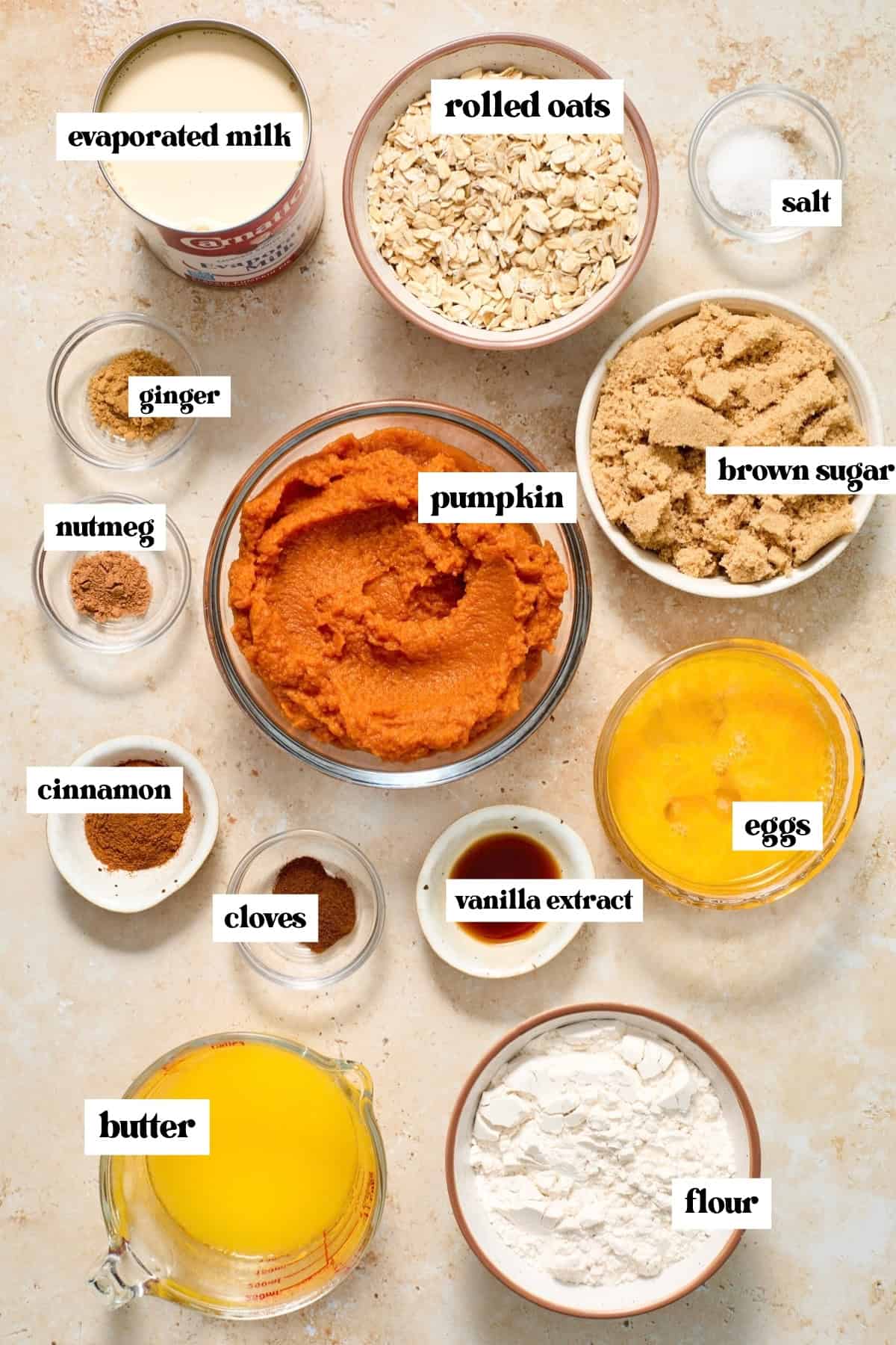 Oats, spices, butter, eggs, and other ingredients labeled on surface.