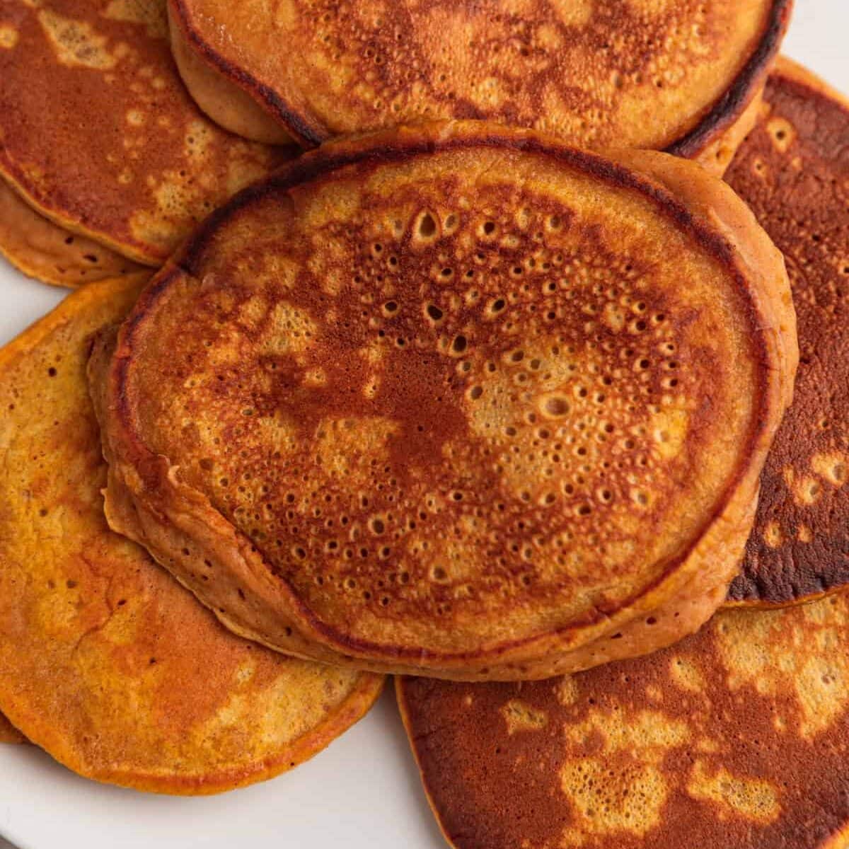 Pumpkin pancakes on plate.