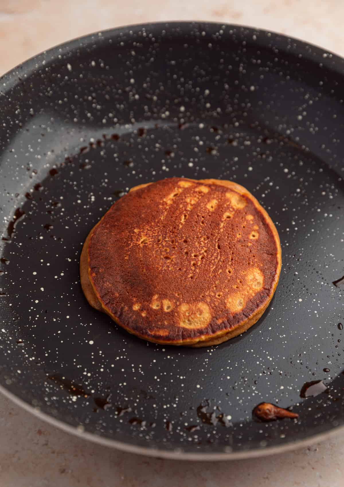Pancake cooked in skillet.