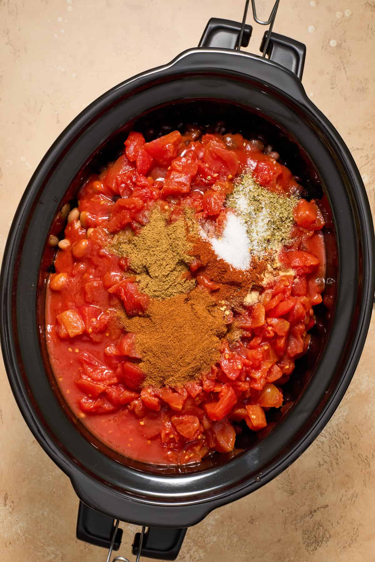 Sweet potato chili ingredients added to crockpot before cooking.